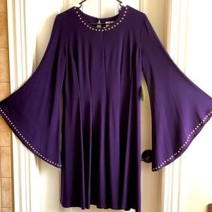 Purple, bell sleeved dress oozes royalty.